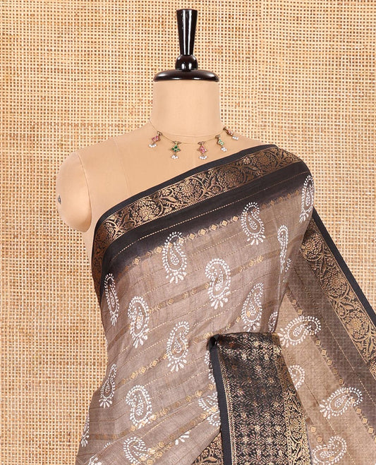 Brown Dola Silk Saree Decked Up with Paisley Buttas, and Horizontal Zari Stripes All Over Its Body, Complemented by Contrast Floral Creeper Zari Design Border, Pallu Steeped with Paisleys, and Paired with a Contrast Blouse