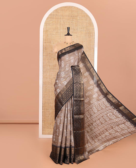 Brown Dola Silk Saree Decked Up with Paisley Buttas, and Horizontal Zari Stripes All Over Its Body, Complemented by Contrast Floral Creeper Zari Design Border, Pallu Steeped with Paisleys, and Paired with a Contrast Blouse