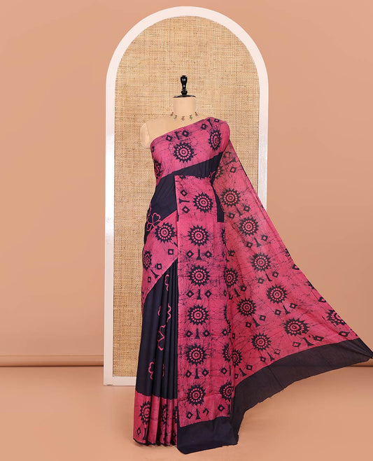 Navy Blue Mul Cotton Saree Accentuated with Batik-Style Floral Motifs Print, Featuring a Batik-Style Geometric Printed Border, Pallu Mirrors the Same Print, and Paired with a Matching Blouse