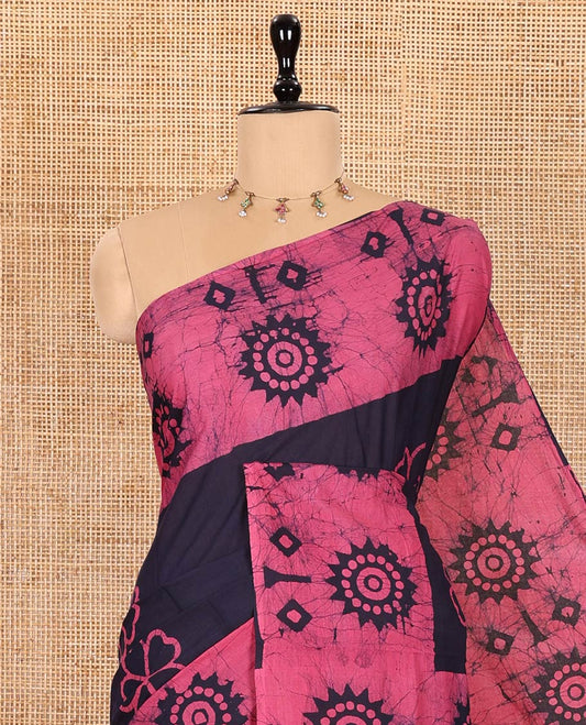 Navy Blue Mul Cotton Saree Accentuated with Batik-Style Floral Motifs Print, Featuring a Batik-Style Geometric Printed Border, Pallu Mirrors the Same Print, and Paired with a Matching Blouse