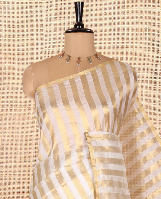 Borderless Off-white Tissue Saree, Entralled with Thick Vertical Golden Zari Stripes All Over Its Body, Highlighted by Gleaming Zari Striped Pallu, and Paired with a Matching Blouse