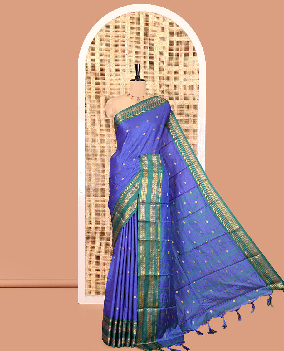 Royal Blue Softy Silk Saree, Accentuated with Zari Buttas All Over Its Body, Complemented by a Contrast Traditional Zari Design Rettai Pettu Border, Pallu Steeped with Buttas, and Paired with a Matching Blouse