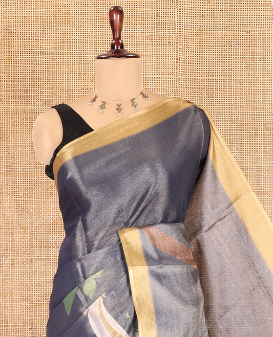 Denim Blue Kerala Culture-Themed Tissue Saree Features a Girl, Banana Leaf, and Kolam Motifs, Contrast Border, and Blouse