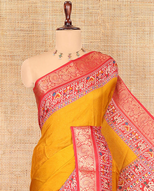 Mustard Embossed Moss Chiffon Saree, Complemented by a Contrast Traditional Zari Patola Printed Border, Patola Pallu, and a Contrast Blouse