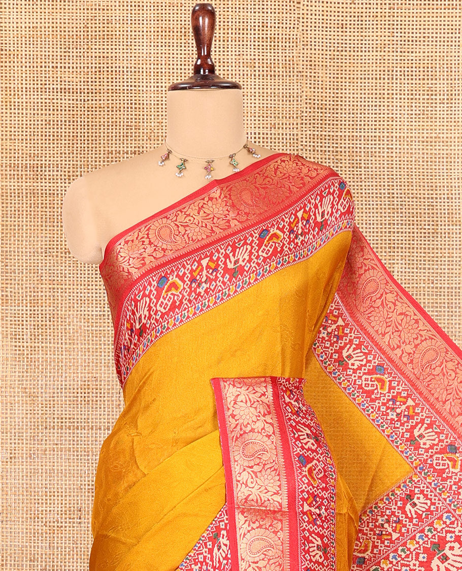 Mustard Embossed Moss Chiffon Saree, Complemented by a Contrast Traditional Zari Patola Printed Border, Patola Pallu, and a Contrast Blouse