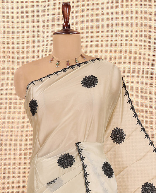 Chikku Chiffon Saree, Gracefully Embellished with Floral Embroidery Buttas, a Lace Embroidered Border, a Contrast Blouse