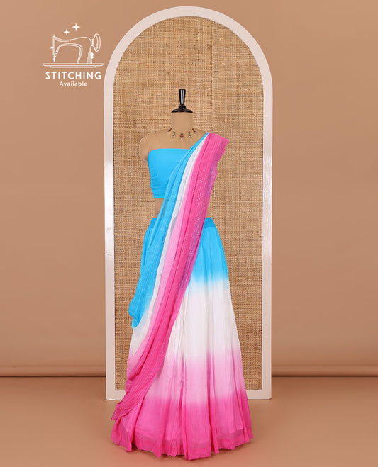Multi-color half-saree, ombre-colored viscose georgette skirt, a plain sky blue blouse, and a ombre-colored zari striped dhavani