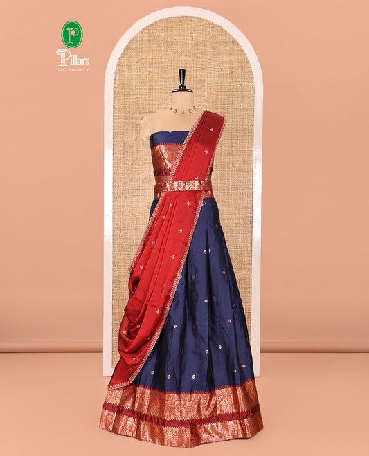 Navy Blue-Red Semi-Banarasi Half-Saree Adorned with Zari Buttas on Its Skirt, Complemented by a Contrast Traditional Zari Temple Rettai Pettu Border, Paired with a Matching Blouse, and a Satin Georgette Embroidered Scallop Dhavani