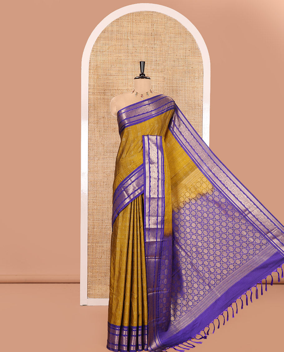 Mustrad Kanchipuram Budget Silk Saree, Decorated with Plus-Sized Butta Enclosed Checks All Over Its Body, Complemented by a Contrast Traditional Zari Border of Round Peacock Designs, Pallu Steeped with Circle Motifs, and Paired with a Contrast Blouse