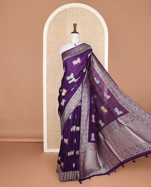 Purple Matka silk saree features Pichwai cow motifs, floral creeper design border, and intricate pallu
