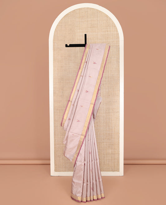 Light Sandal Uppada Silk Saree, Sparsely Woven with Floral Buttas on Its Body, Highlighted by a Contrast Zari Bavanji Border, Pallu of Floral Designs, and Paired with a Matching Blouse