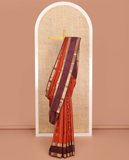 Orange Vasundhara Lite-Silk Mix Saree, Prettified with Zari Buttas, Complemented by Contrast Rettai Pettu Border Featuring Thilakam, Ara Bogudi, Neli, and Kamalam Designs, Grandly Woven Pallu of Floral Designs, and Paired with a Contrast Blouse