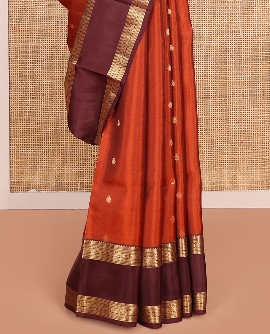 Orange Vasundhara Lite-Silk Mix Saree, Prettified with Zari Buttas, Complemented by Contrast Rettai Pettu Border Featuring Thilakam, Ara Bogudi, Neli, and Kamalam Designs, Grandly Woven Pallu of Floral Designs, and Paired with a Contrast Blouse