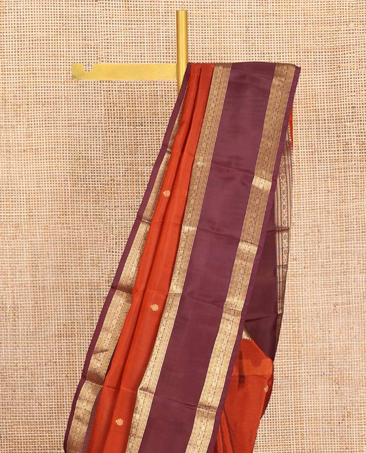 Orange Vasundhara Lite-Silk Mix Saree, Prettified with Zari Buttas, Complemented by Contrast Rettai Pettu Border Featuring Thilakam, Ara Bogudi, Neli, and Kamalam Designs, Grandly Woven Pallu of Floral Designs, and Paired with a Contrast Blouse