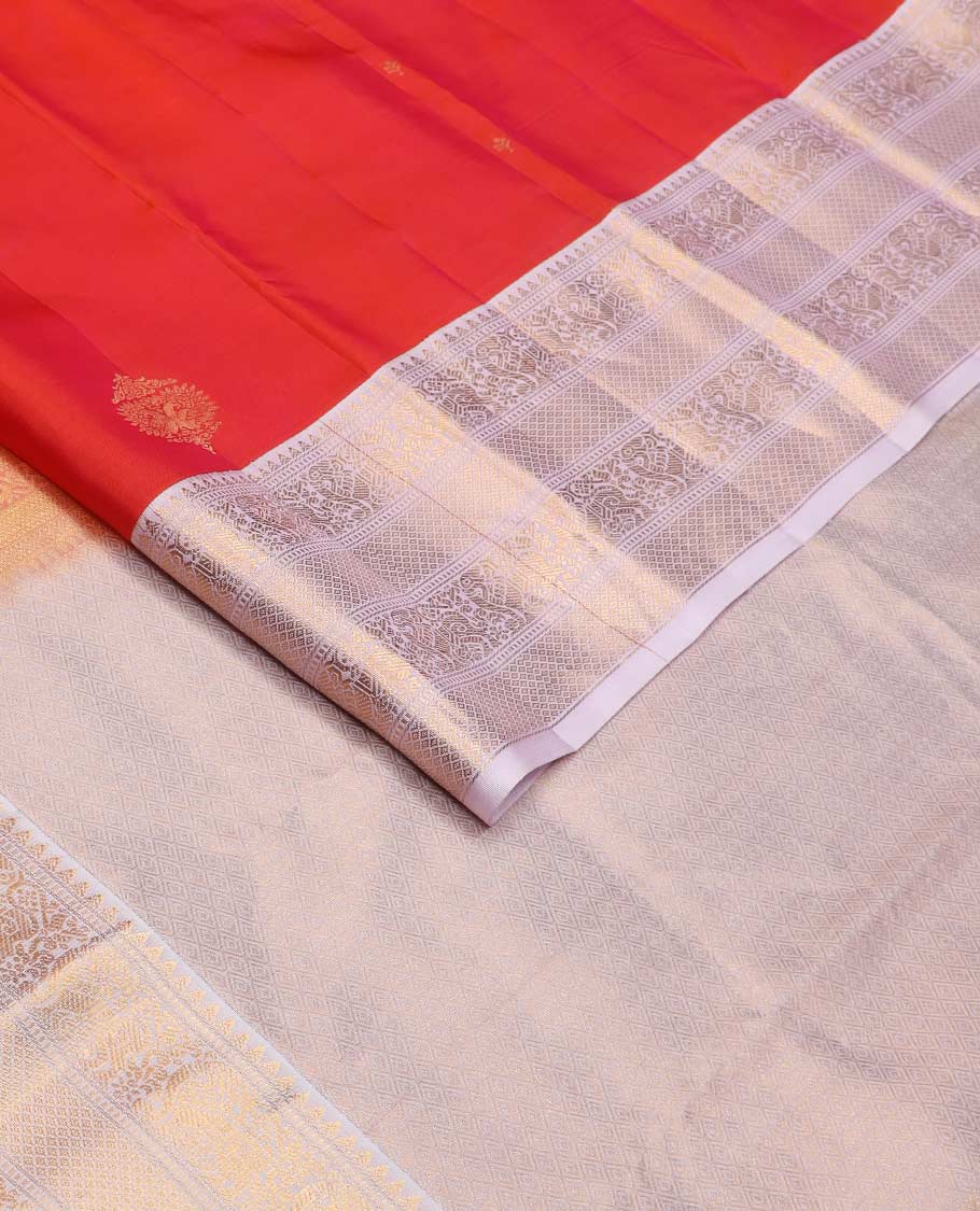 Orange zari buttas Vasundhara silk mix saree, contrast border of rekku, muthu, yaali, and mayil kann designs, and jaal pallu