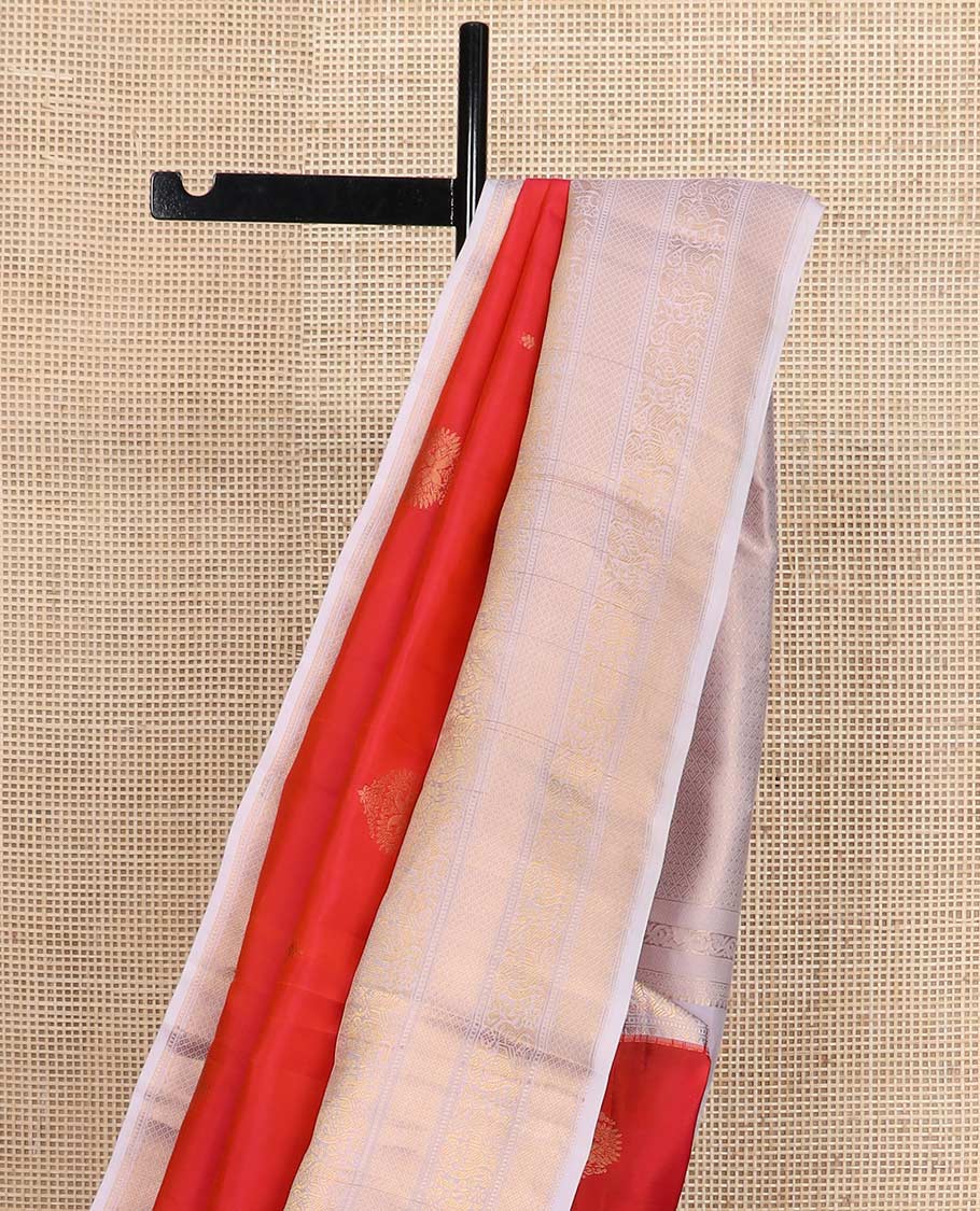 Orange zari buttas Vasundhara silk mix saree, contrast border of rekku, muthu, yaali, and mayil kann designs, and jaal pallu
