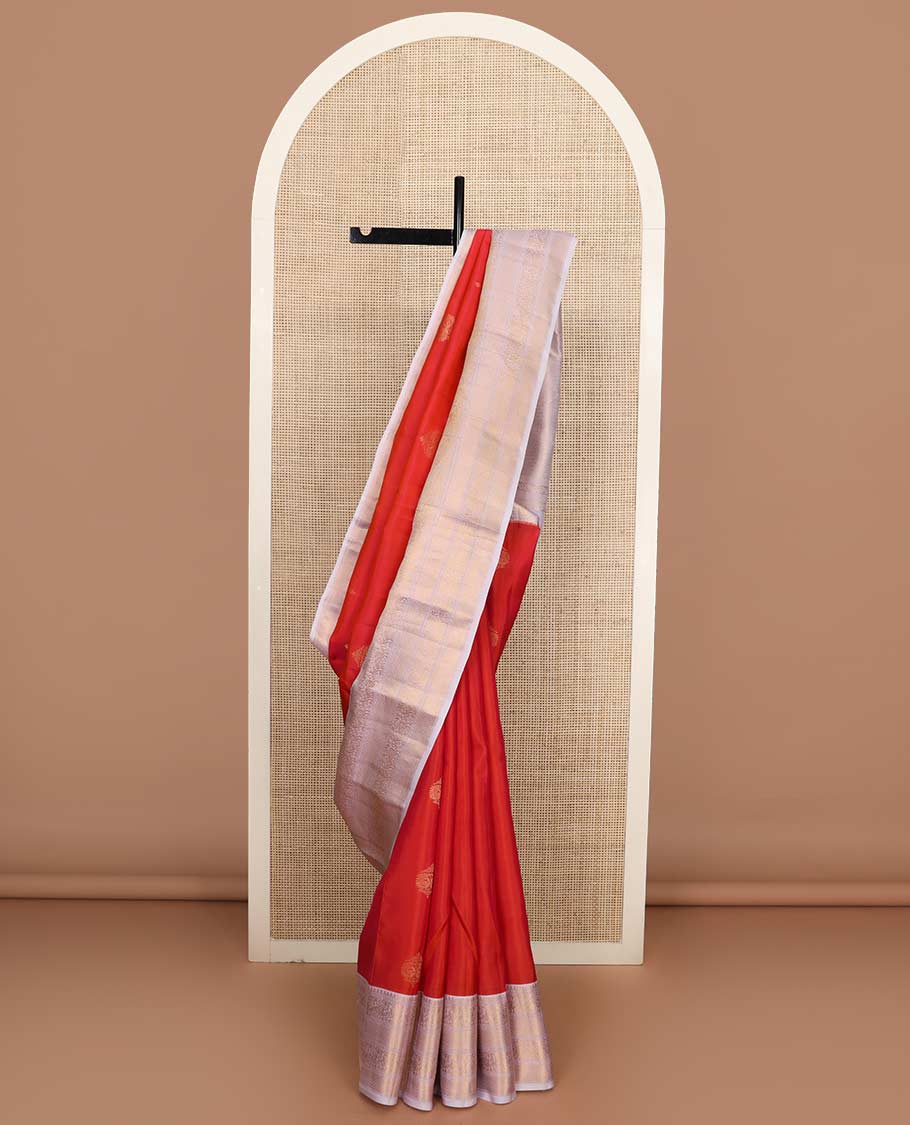 Orange zari buttas Vasundhara silk mix saree, contrast border of rekku, muthu, yaali, and mayil kann designs, and jaal pallu
