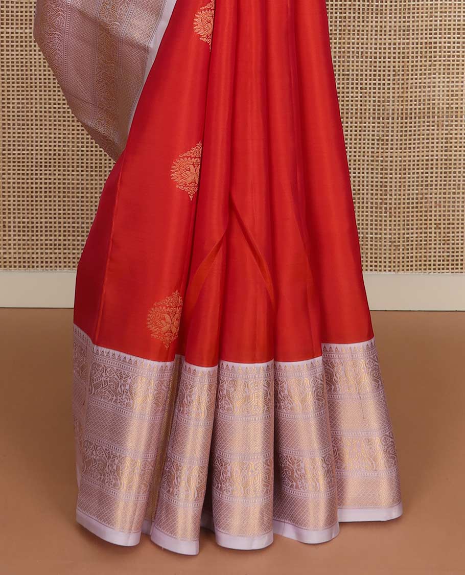 Orange zari buttas Vasundhara silk mix saree, contrast border of rekku, muthu, yaali, and mayil kann designs, and jaal pallu