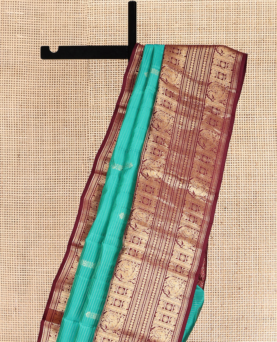 Green Vasundhara Lite Silk Mix Saree, Decked Up with Buttas and Stripes, Complemented by a Contrast Border of Bentex, Mayil Kann, Mayil, and Chakra, Intricate Pallu, and a Contrast Blouse