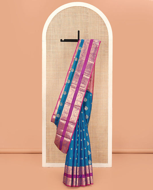Blue Vasundhara Lite Silk Mix Saree, Prettified with Zari Buttas on Its Body, Complemented by a Contrast Rettai Pettu Border of Thilakam Mokku, and Kodi Visiry Designs, Opulently Embellished Pallu, and Paired with a Contrast Blouse