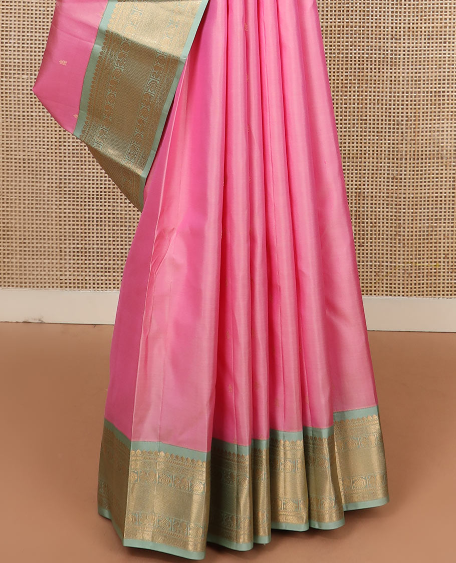 Pink zari buttas silk saree, contrast border of thilakam mokku, jaal, manga, and mayil designs, and Mughal-style intricate pallu