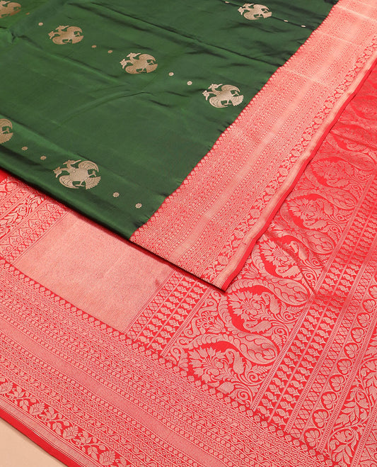 Green iruthalai pakshi buttas silk saree with contrast border of thilakam mokku, leaf vine, paisa, and kodi visiry designs, and intricate pallu