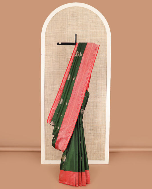 Green iruthalai pakshi buttas silk saree with contrast border of thilakam mokku, leaf vine, paisa, and kodi visiry designs, and intricate pallu