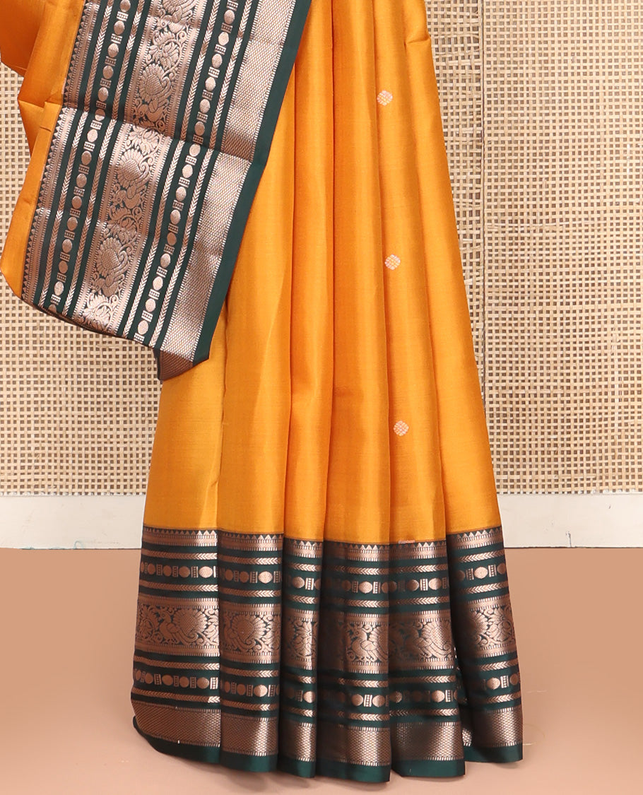 Yellow Vasundhara Silk Saree, Prettified with Zari Buttas All Over Its Body, Complemented by Contrast Border of Rekku, Muthu, Kathir, Poun, Mayil, and Mayil Kann Designs, Grand Jaal Pallu and Paired with a Contrast Blouse