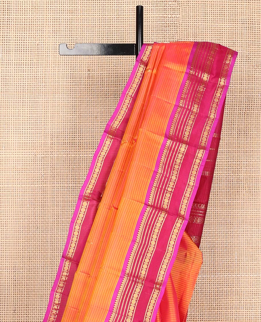 Orange striped and buttas Kanchipuram silk saree, contrast border and pallu of thilakam mokku, muthu, neli, and rudraksham designs