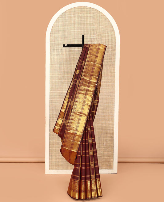 Brown iruthalai pakshi buttas Kanchipuram silk saree, zari border of thilakam mokku, muthu, rudraksham, kathir, round mayil, and paiyaadi kattam, and manga butta enclosed jaal pallu