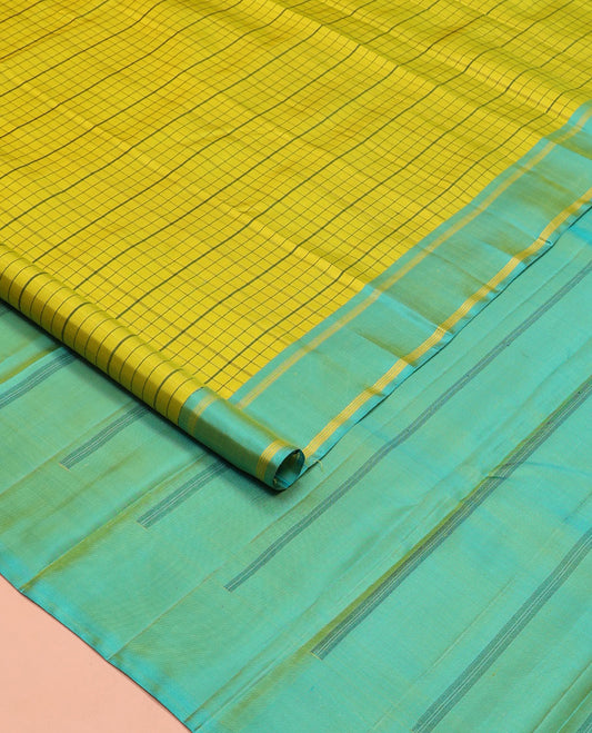 Green checked Kanchipuram silk saree, contrast striped border, and pallu of stripes