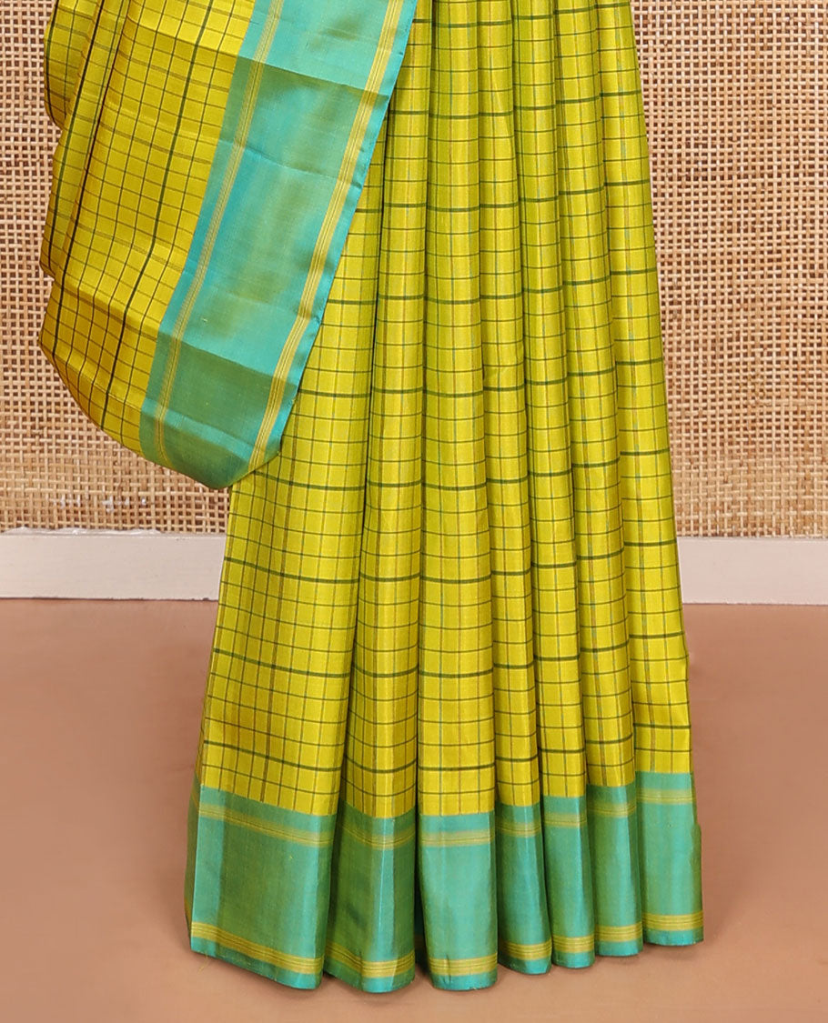 Green checked Kanchipuram silk saree, contrast striped border, and pallu of stripes