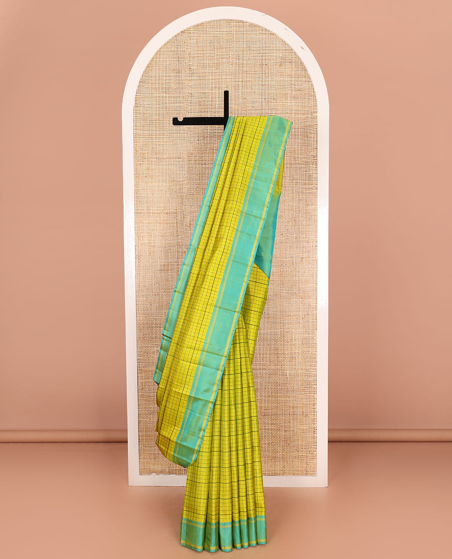 Green checked Kanchipuram silk saree, contrast striped border, and pallu of stripes