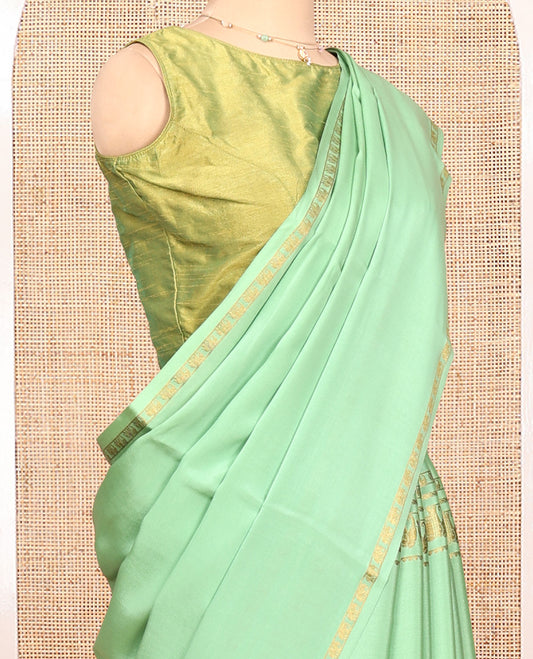 Green Plain Mysore Silk Saree, Highlighted by Traditional Zari Border of Elephant Motifs, Subtly Zari Striped Pallu, and Paired with a Matching Blouse