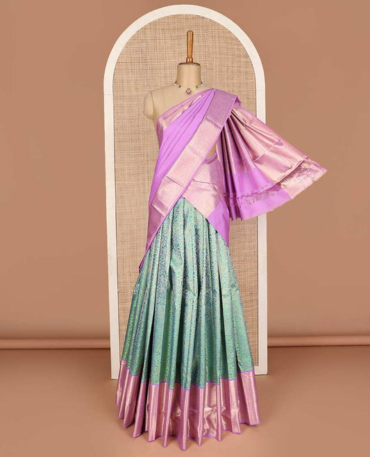 Green pure-silk half saree, jacquard with contrast traditional zari bordered skirt, blouse of thilakam, muthu, mayil kann,  kodi visiry, and kamalam motifs, and zari design dhavani