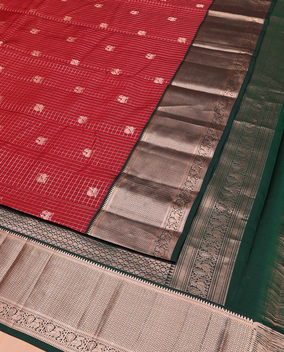 Red Vasundhara Silk Saree Embellished with Mayil-Yaali Buttas and Zari Checks, Complemented by a Contrast Border of Rekku, Muthu, Kuyil Kann, and Mayil Designs, Pallu Majestically Detailed with Geometric Designs, and Paired with a Matching Blouse