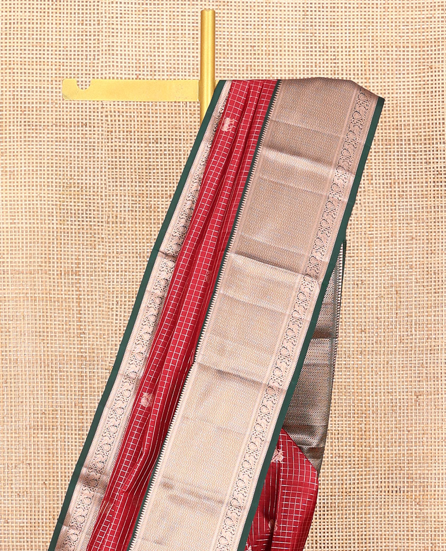 Red Vasundhara Silk Saree Embellished with Mayil-Yaali Buttas and Zari Checks, Complemented by a Contrast Border of Rekku, Muthu, Kuyil Kann, and Mayil Designs, Pallu Majestically Detailed with Geometric Designs, and Paired with a Matching Blouse