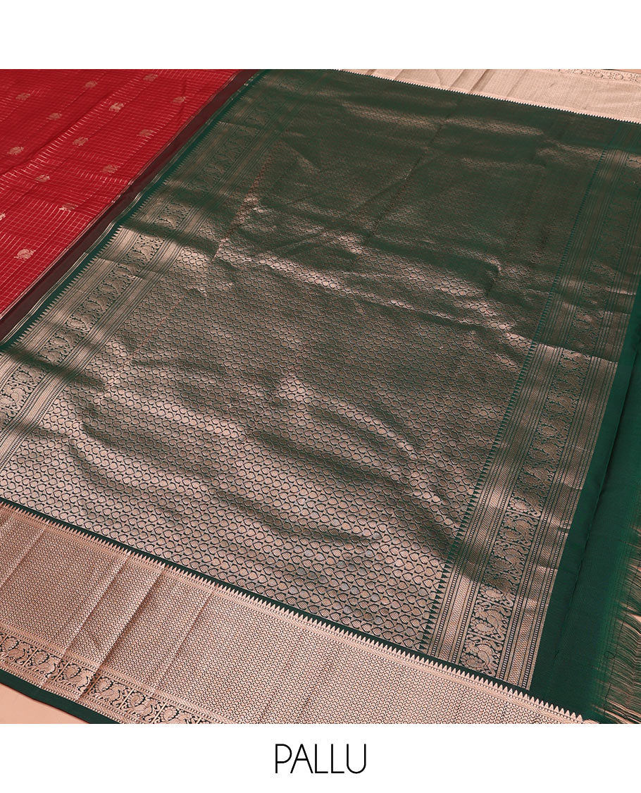 Red Vasundhara Silk Saree Embellished with Mayil-Yaali Buttas and Zari Checks, Complemented by a Contrast Border of Rekku, Muthu, Kuyil Kann, and Mayil Designs, Pallu Majestically Detailed with Geometric Designs, and Paired with a Matching Blouse