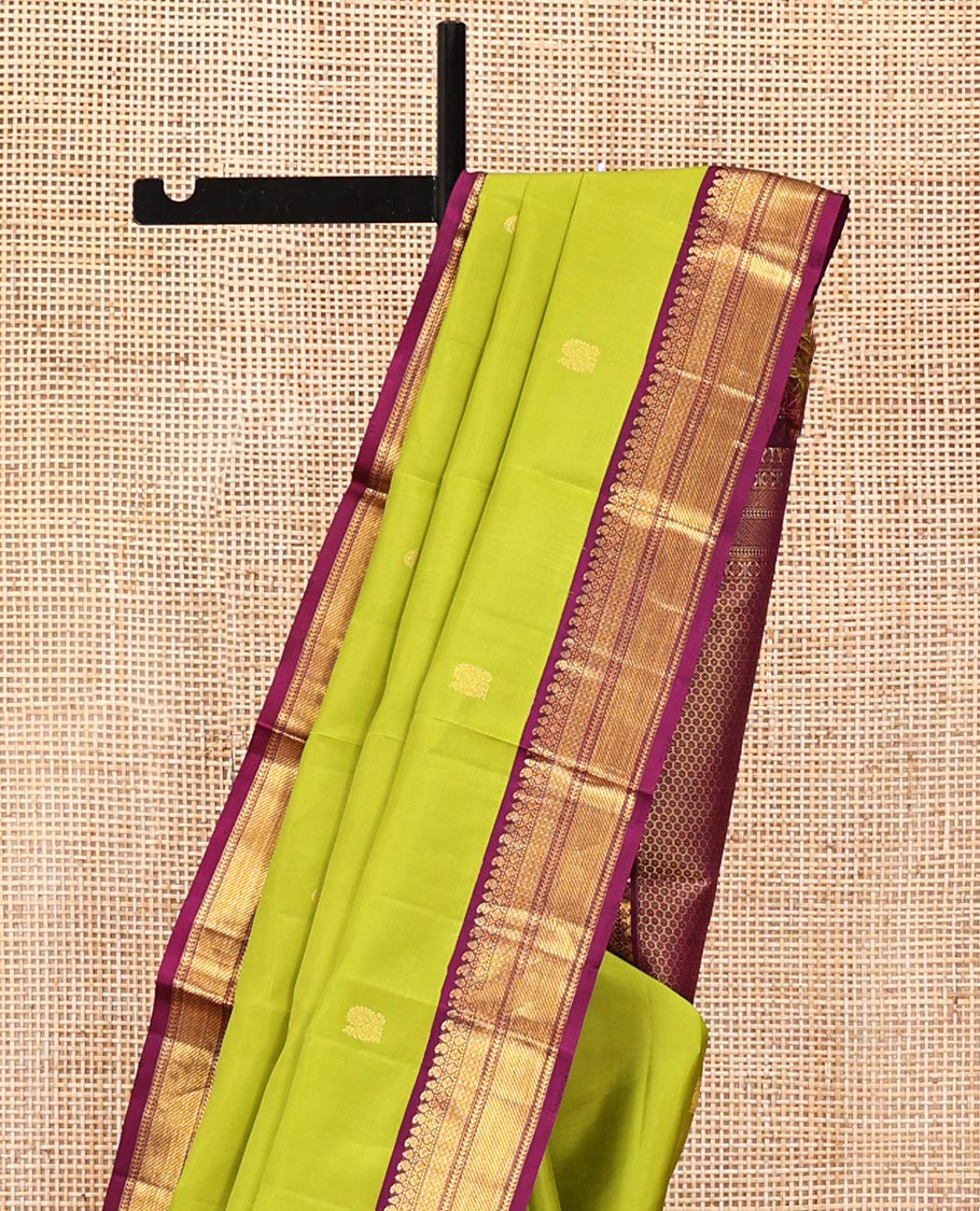 Green Vasundhara Silk Saree, Prettified with Zari Buttas All Over Its Body, Complemented by a Contrast Border of Thilakam, Manga, Muthu, Ara Bogudi, and Mayil Kann Designs, Grand Pallu, and Paired with a Contrast Blouse
