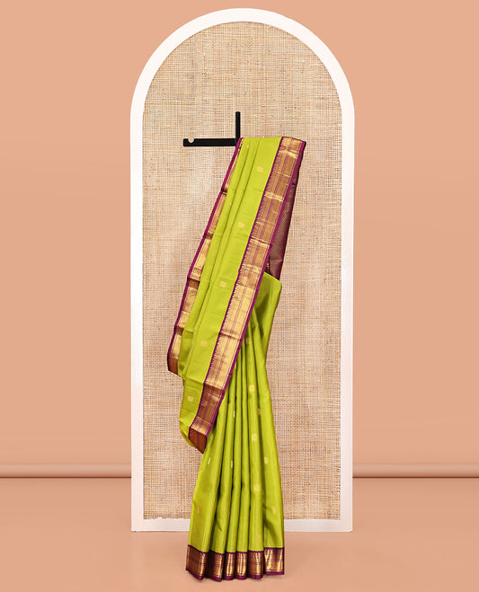 Green Vasundhara Silk Saree, Prettified with Zari Buttas All Over Its Body, Complemented by a Contrast Border of Thilakam, Manga, Muthu, Ara Bogudi, and Mayil Kann Designs, Grand Pallu, and Paired with a Contrast Blouse