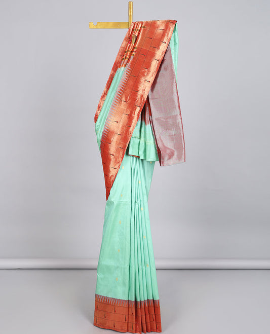 Green paithani silk saree with zari buttas, contrast vidarbha triple muniya border & pallu of colorful floral designs