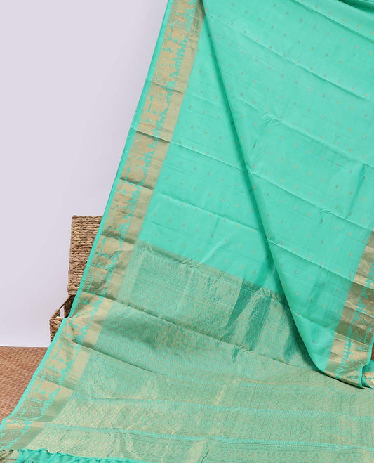 Green silk saree with zari buttas, zari-rich manga design pallu & zari border of wedding-theme motifs weave