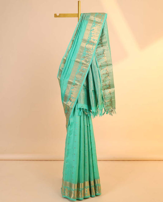 Green silk saree with zari buttas, zari-rich manga design pallu & zari border of wedding-theme motifs weave