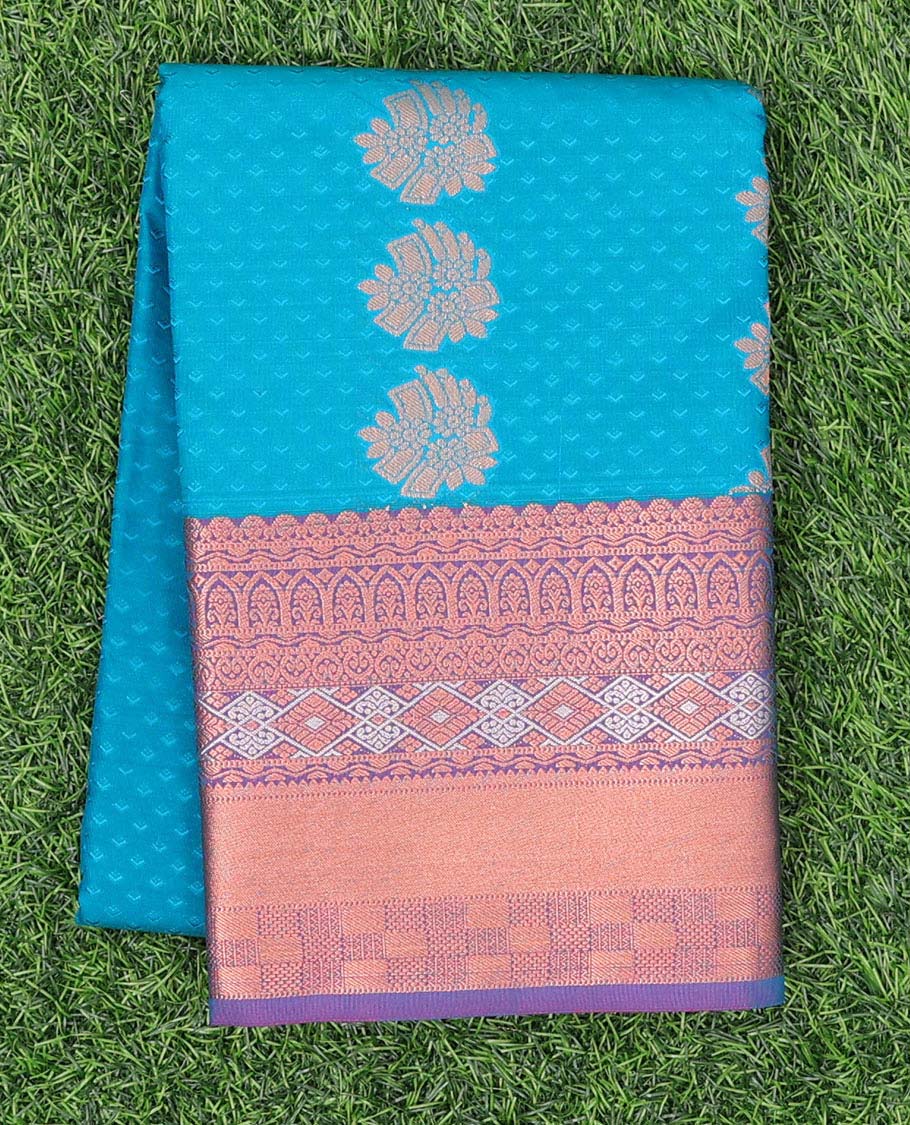 Blue embossed art silk pavadai with buttas, contrast blouse & border of traditional zari designs