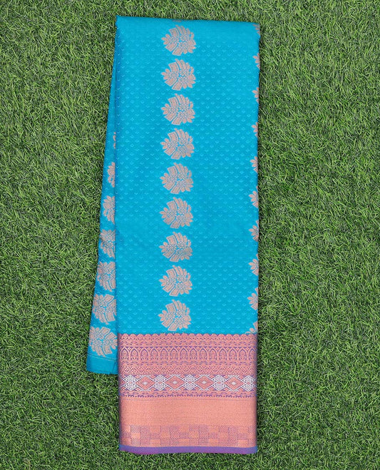 Blue embossed art silk pavadai with buttas, contrast blouse & border of traditional zari designs