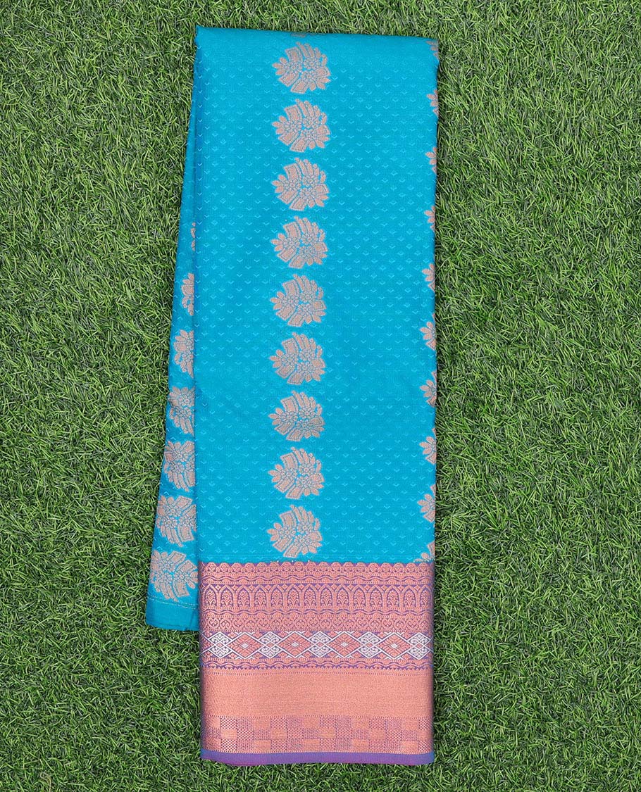 Blue embossed art silk pavadai with buttas, contrast blouse & border of traditional zari designs