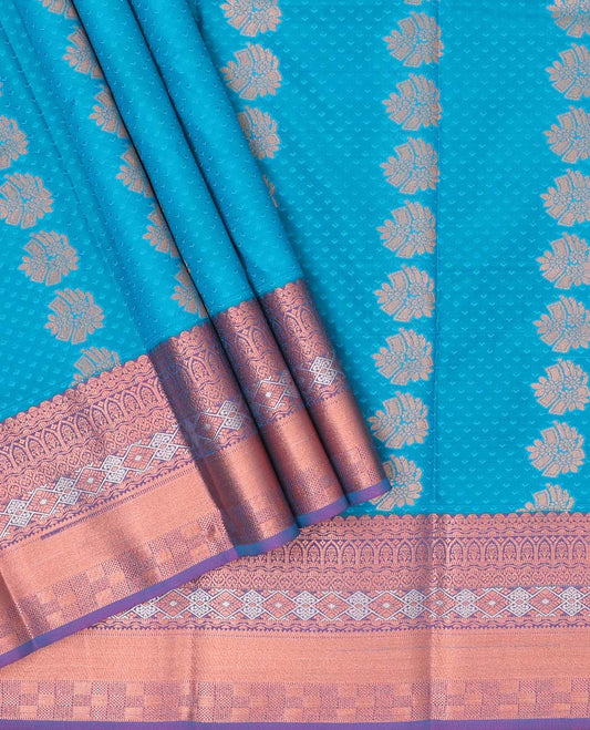 Blue embossed art silk pavadai with buttas, contrast blouse & border of traditional zari designs