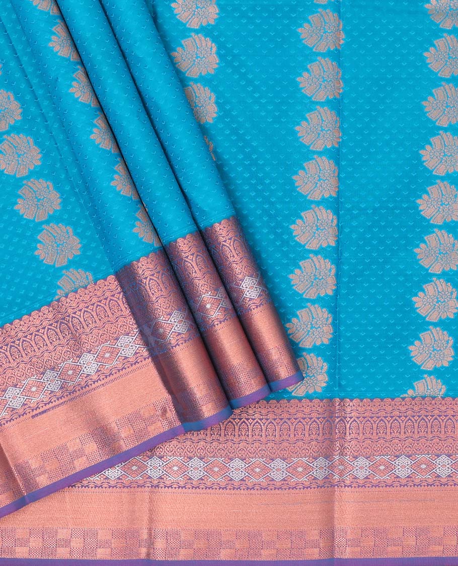 Blue embossed art silk pavadai with buttas, contrast blouse & border of traditional zari designs