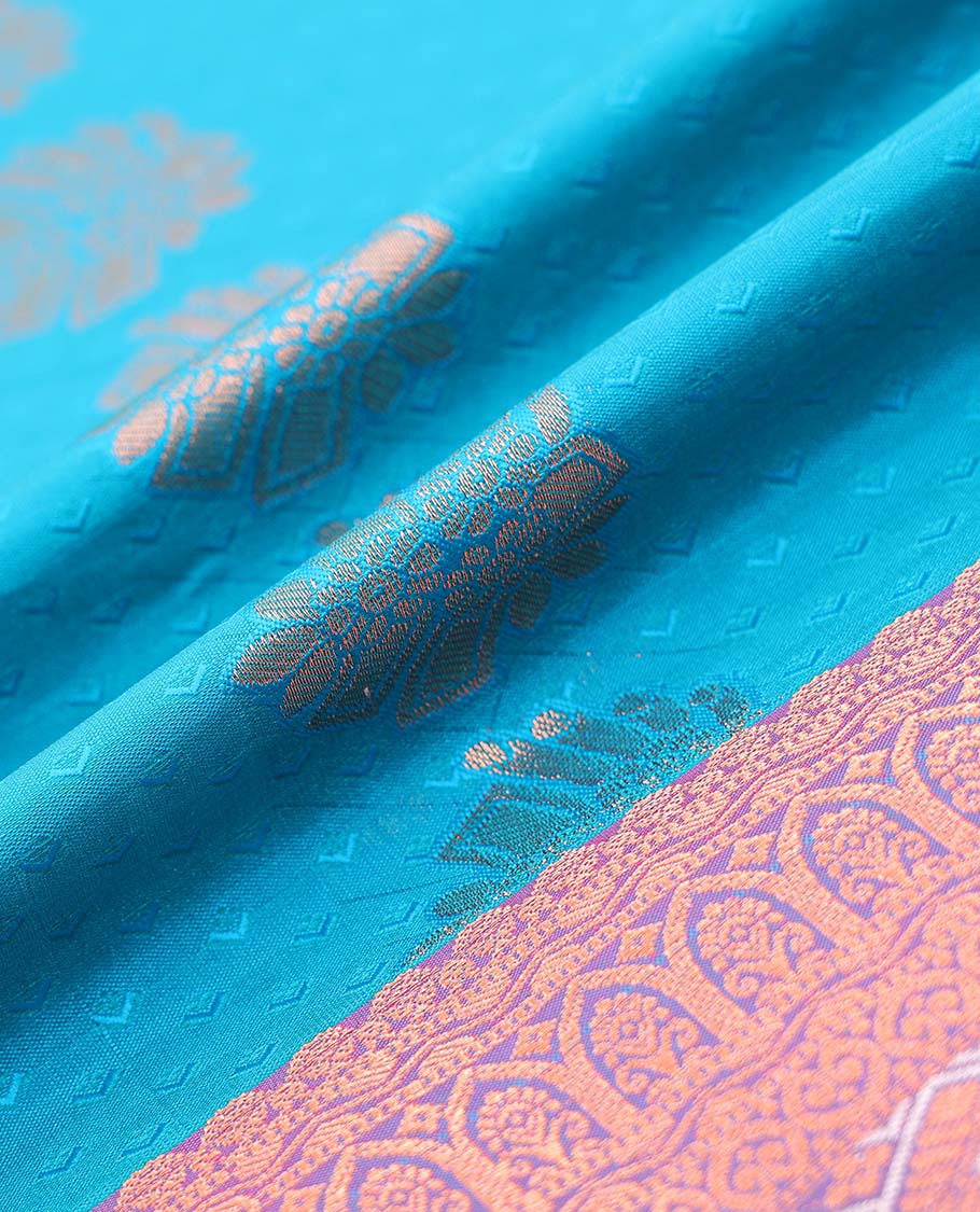 Blue embossed art silk pavadai with buttas, contrast blouse & border of traditional zari designs