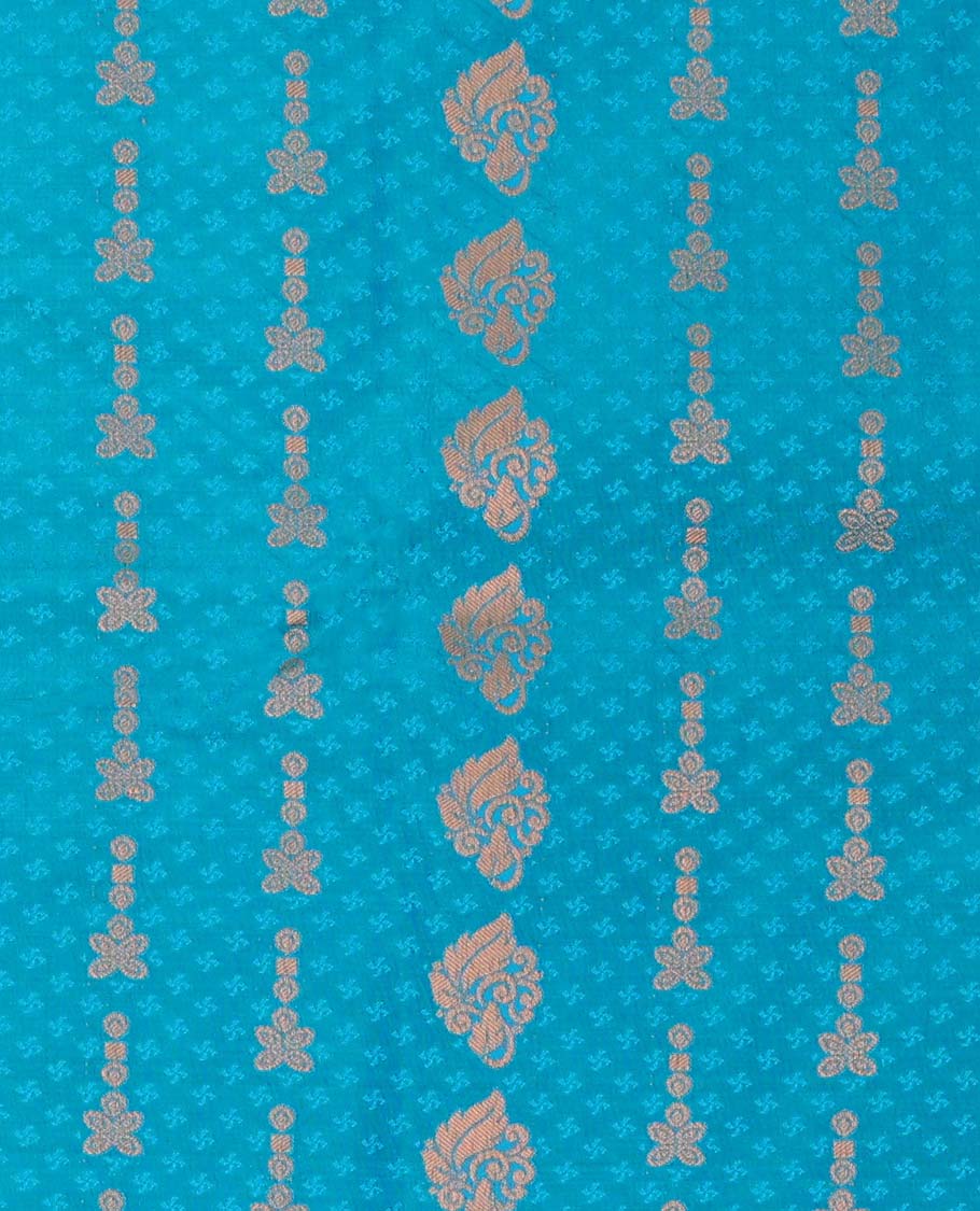 Blue embossed art-silk pavadai with zari buttes, contrast blouse & border of traditional designs